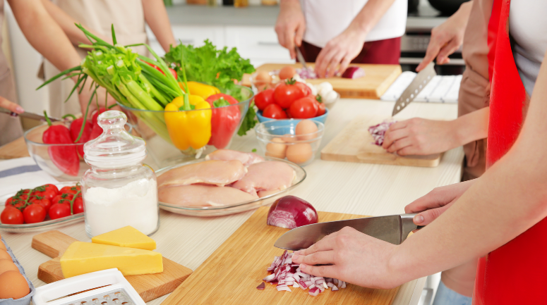 aula de chef profissional com uma mesa e alimentos sendo manuseados destacando o cursos profissionalizantes de gastronomia
